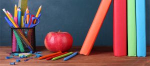 Education-apple, pencils, and books on a desk