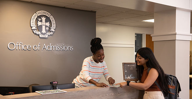 Admissions receptionist helping a student